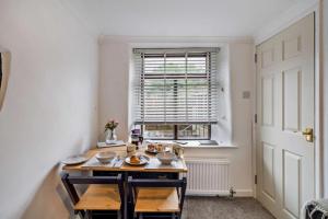 a room with a table with bowls on it with a window at Quarter Deck in Ulverston