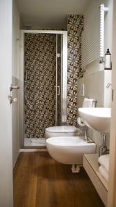 a bathroom with a toilet and a sink and a shower at Rex Hotel Residence in Genoa