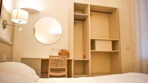 a bedroom with a desk and a mirror at Rex Hotel Residence in Genoa