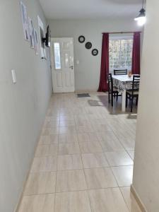 a living room with a tiled floor and a dining room at Hermoso Departamento en Quines in Quines
