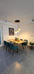 a dining room with a wooden table and chairs at Prime Line in Bortianor