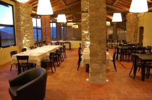 a dining room with tables and chairs and windows at Azienda Agricola La Ghibellina in Gavi