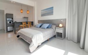 a bedroom with a large bed with blue pillows at Nacar Apart Hotel in Santa Teresita