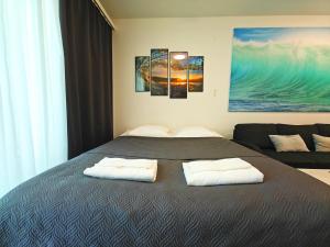 a bedroom with a bed with two white pillows at Top location IICenter IIParking in Oulu