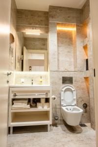 a bathroom with a sink and a toilet and a mirror at Apartman Dunja Zepterme in Vrnjačka Banja +40 photos