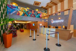 a hospital lobby with a christmas tree in the center at Intercity Salvador in Salvador