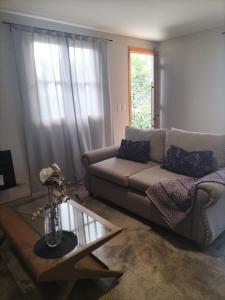 a living room with a couch and a coffee table at Relax MDZ - Memorable Apt in Godoy Cruz