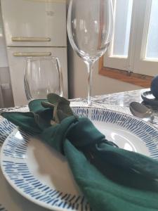 a plate with a wine glass and a green napkin at Relax MDZ - Memorable Apt in Godoy Cruz +19 photos