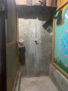 a bathroom with a shower with a rainbow on the wall at Casa de la abuela in San Marcos La Laguna