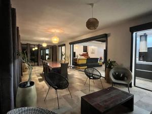 a living room with chairs and a table at Villa passion vanille in Les Trois-Îlets