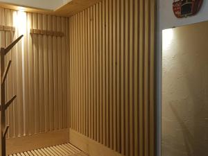 a room with a wooden paneled wall and a door at Confortable 2 pièces cabine au pied des pistes - 7 pers, balcon, ascenseur - FR-1-411-708 in Bourg-Saint-Maurice
