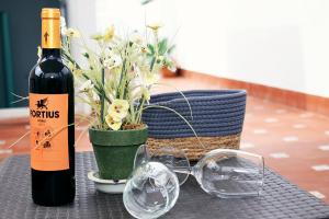 a bottle of wine and glasses on a table at Apartment in the center of La Cala de Mijas with Sea Views in Mijas