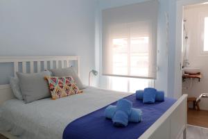 a bedroom with a bed with blue pillows on it at Apartment in the center of La Cala de Mijas with Sea Views in Mijas +22 photos
