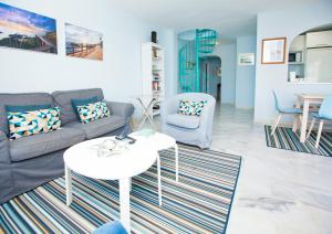 a living room with a couch and a table at Apartment in the center of La Cala de Mijas with Sea Views in Mijas