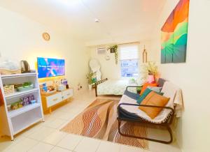 a living room with a couch and a table at Urban Deca Homes Tondo Manila - by ADStaycation in Manila