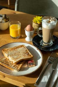a plate with two slices of toast and a cup of coffee at Aloft London Excel in London