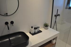 a bathroom with a black sink and a mirror at Villa Irene Tolo in Tolo +11 photos