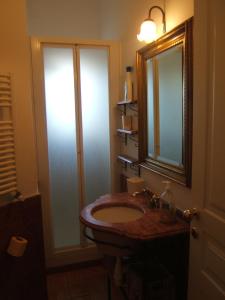a bathroom with a sink and a mirror at Olivella Suite Ecological House in Palermo