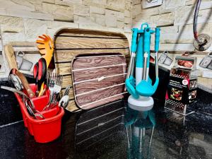 a painting of a kitchen with some utensils at ALEX HOMES - Stanley Cozy Apartments with Direct Sea View in Alexandria +42 photos