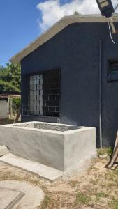 a house with a concrete foundation in front of it at Cuchilla Alta-La Cabaña Celeste in Cuchilla Alta