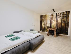 a bedroom with a large bed and a piano at Fine Living - Zentral, barrierefrei mit Terrasse & 24h Parkhaus in Nähe in Peine