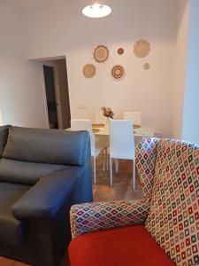 a living room with a couch and a table at VUT Casa de la Catedral Baja in Sigüenza