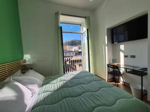 a bedroom with a bed and a window with a view at Appartamento Annunziata in Naples