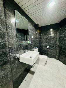 a bathroom with a white sink and a mirror at Will Guest Homestay in Ella +131 photos