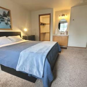 a bedroom with a large bed and a bathroom at Sunstone House in Portland