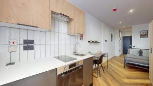 a kitchen with a sink and a counter top at The Thurloe Studios in Manchester