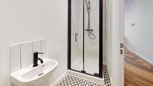a bathroom with a sink and a shower at The Thurloe Studios in Manchester