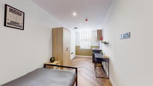 a bedroom with a bed and a desk in it at The Thurloe Studios in Manchester +17 photos