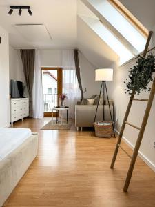 a bedroom with a bed and a living room at PARKOVA APARTAMENTY - termy, centrum, park in Jelenia Góra