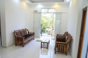 a living room with two chairs and a table at 19 Southern Homestay in Dickwella