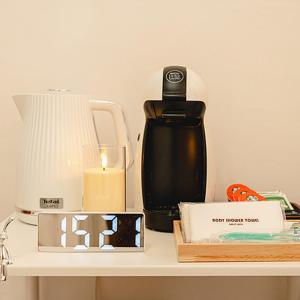 a table with a candle and a bottle of water at Noddle Sun Stay in Seoul