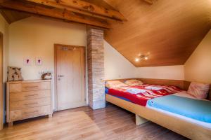 A bed or beds in a room at Vila Studienka