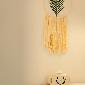 a wall with a clock and a dream catcher at Noddle Sun Stay in Seoul