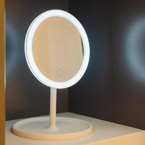 a white mirror on a stand on a table at Noddle Sun Stay in Seoul