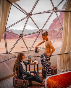 a young man standing in a room with a woman at Wadi Rum Relaxation Camp in Wadi Rum
