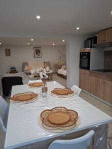 a table with two hats on top of it in a kitchen at Les châtillonnes 25 minutes du zoo de beauval in Châtillon-sur-Indre