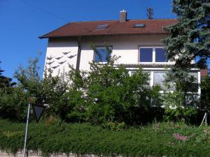 a white house with a red roof at Apartment Seven Ducks in Aalen