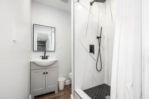 a white bathroom with a sink and a shower at City View Condo with 3 Beds Free Parking LM 07 in Atlanta