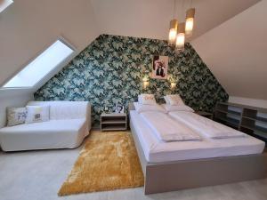a bedroom with two beds and a couch at Silver Lodge Boutique Rooms Eger in Eger