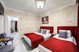 una camera con due letti rossi e bianchi di Zeeenu Abode Yercaud by GD a Yercaud