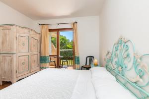 Posteľ alebo postele v izbe v ubytovaní Hotel Piccolo Pevero