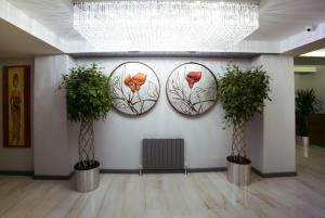 a room with three potted plants on a wall at Ankacity Suit Flat in Ankara