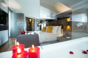 a living room with a couch and two red candles at Ankacity Suit Flat in Ankara