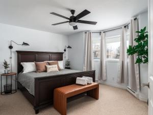 a bedroom with a bed and a ceiling fan at Ski in out at La Halte Mont-Blanc 2 in Mont-Blanc
