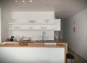a kitchen with a sink and a counter top at Sunrise House 26 in Ponta Delgada