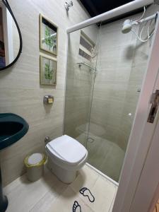 a bathroom with a shower and a toilet and a sink at Hian's Place 01 in Foz do Iguaçu +5 photos